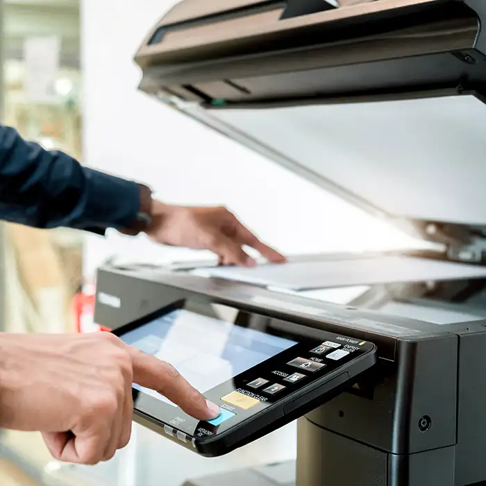 person using office printer to scan document