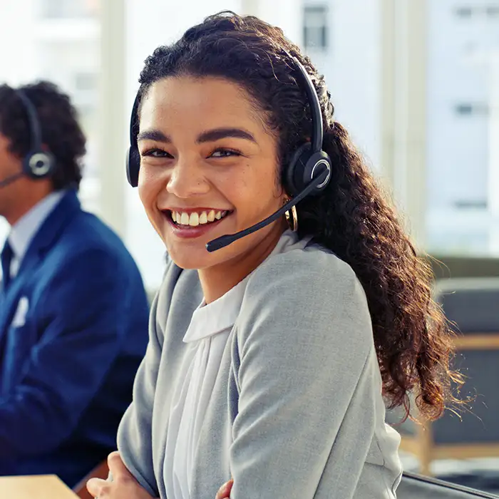 woman smiling with headset on in office