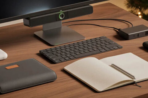 A desk featuring a computer, keyboard, mouse, and an open notebook