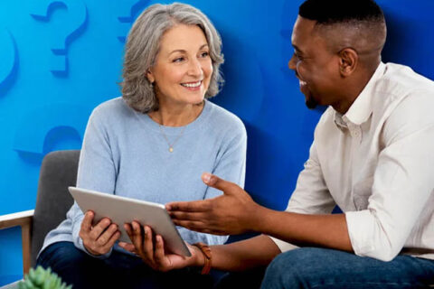 man and woman looking at tablet