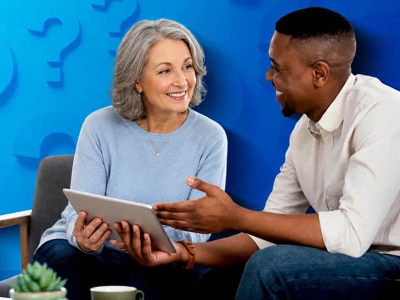 man and woman looking at tablet