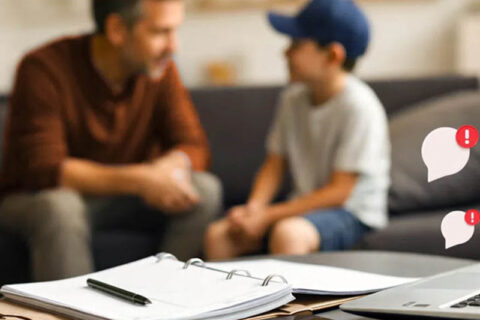 A man and a boy are seated on a couch